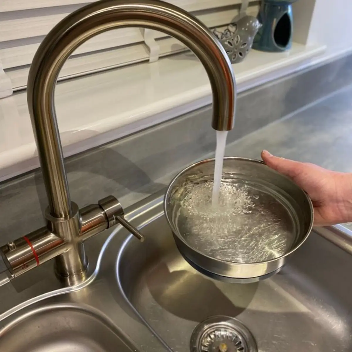 Plumber fixing dripping tap in Sydney home